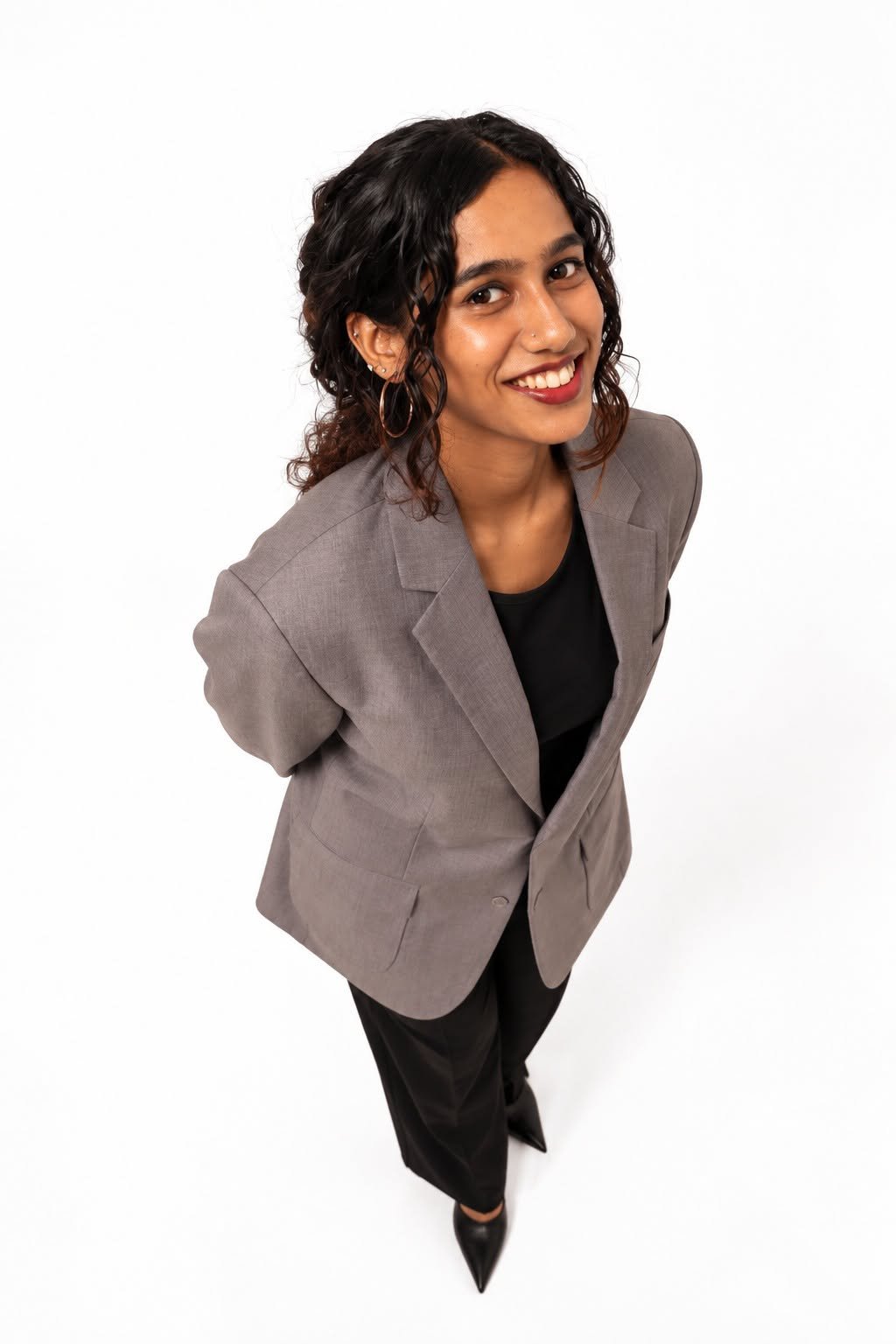 Akshaya Parthiban, Founder and Creative Director of Sequence Studio, wearing a grey blazer.